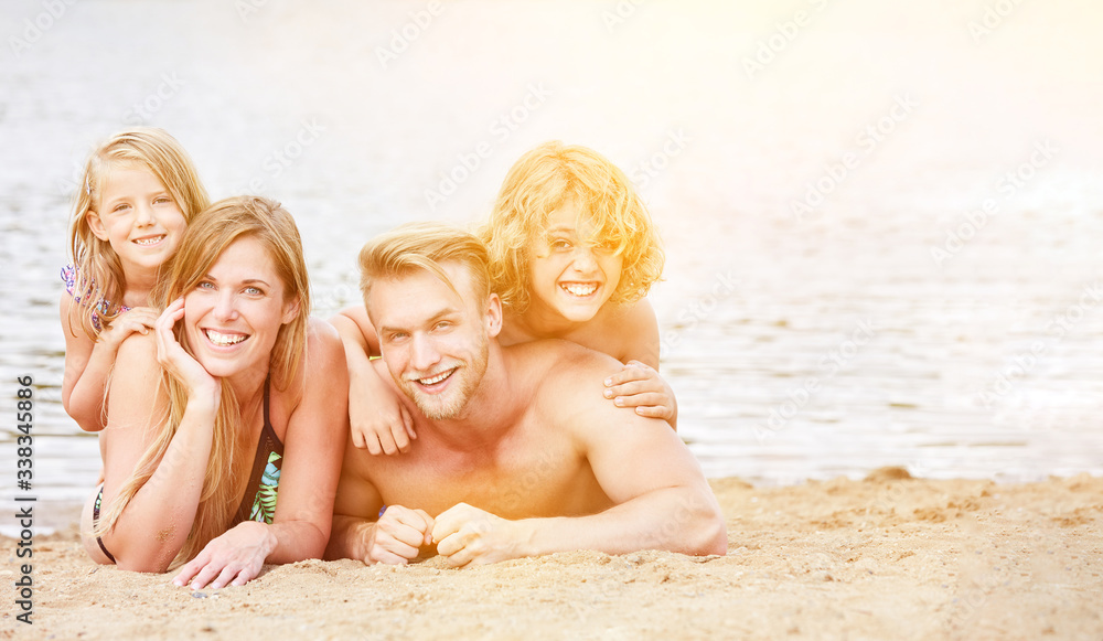 Familie mit zwei Kindern am Strand im Sommer Familie mit zwei Kindern am Strand im Sommer