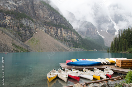 Colourful Canadian wooden canoes on lake in British Columbia, Canada