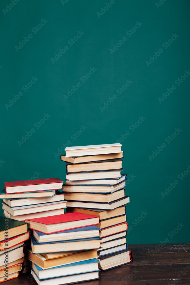 many stacks of educational books to teach in the school library on a green background many stacks of educational books to teach in the school library on a green background