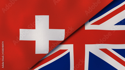 The flags of Switzerland and United Kingdom. News, reportage, business background. 3d illustration