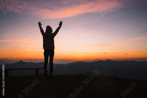 Silhouette of Christian woman praying worship at sunset. Christian Religion concept background. Hands  in prayer. worship god with religion concept.