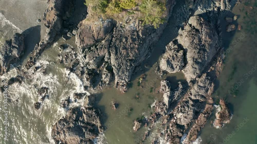Drone looking down at the water break on rocks on Vancouver Island in Sooke British Columbia Canada Drone looking down at the water break on rocks on Vancouver Island in Sooke British Columbia Canada