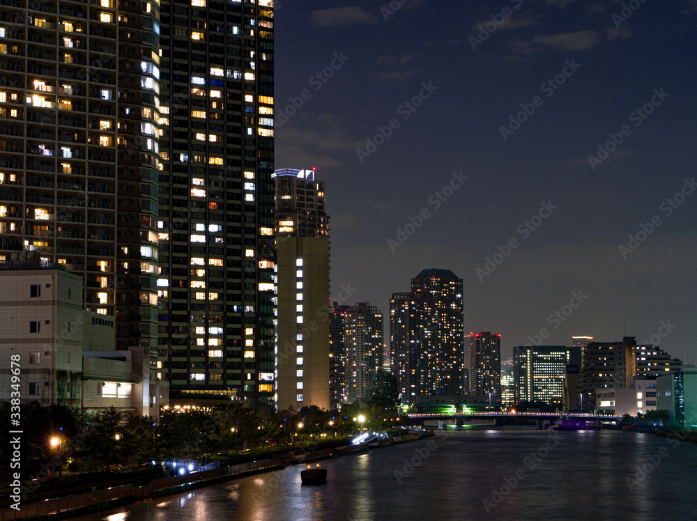 High rise buildings in Tokyo reflected in a river