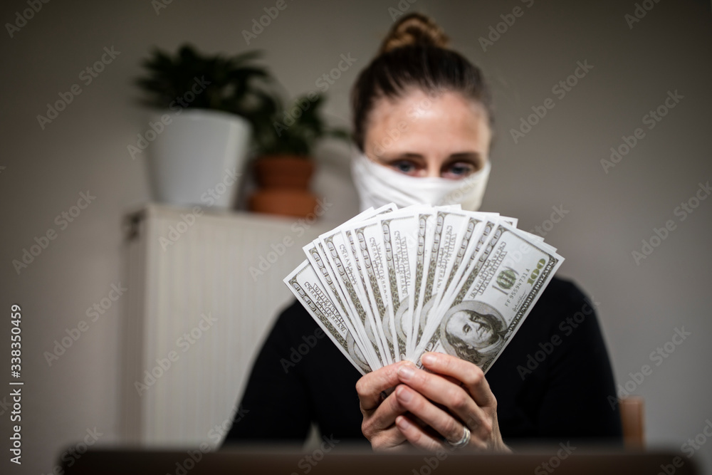 Woman counting money bills during corona time. Woman counting money bills during corona time.