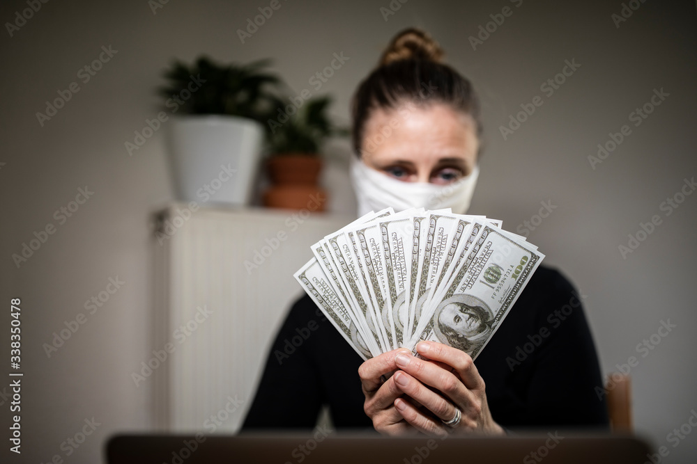 Sad woman counting money bills during corona time. Sad woman counting money bills during corona time.