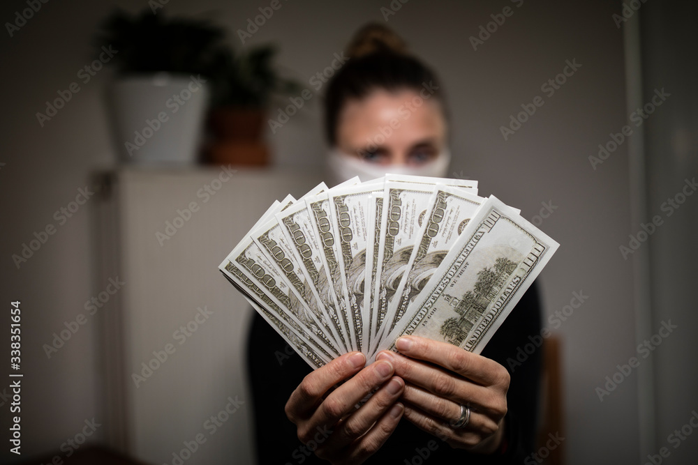 Woman counting money bills during corona time. Woman counting money bills during corona time.