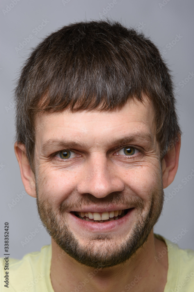 The closeup portrait of a smiling man The closeup portrait of a smiling man