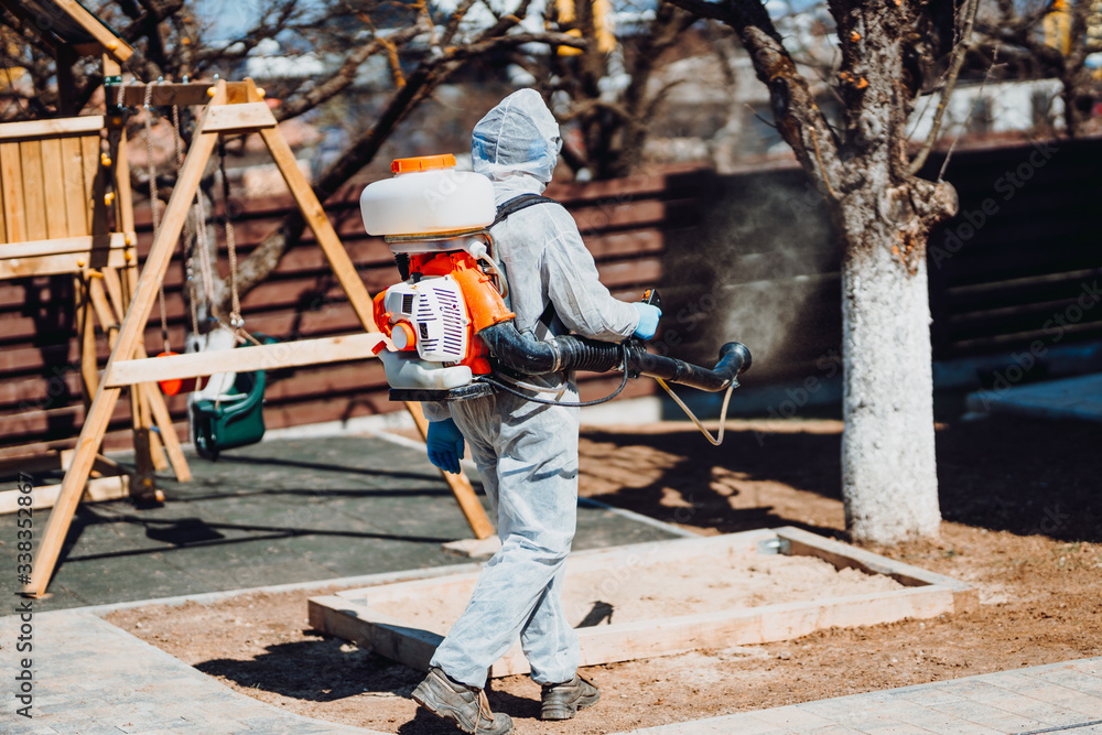 Cleaning specialist in hazmat suits cleaning, disinfecting and decontaminating during coronavirus outbrake Cleaning specialist in hazmat suits cleaning, disinfecting and decontaminating during coronavirus outbrake