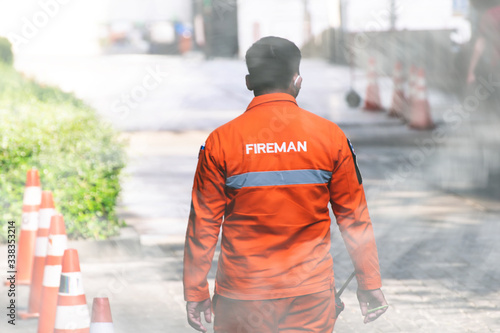 Fireman.Fireman working on the ground with smoke. © Chinnachote