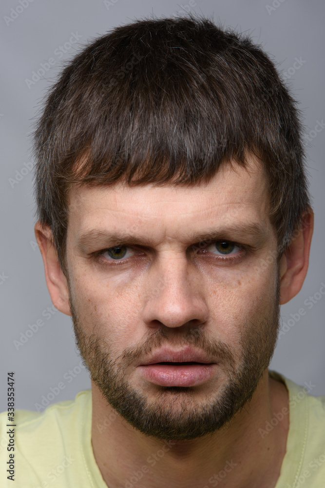 Close-up portrait of a gloomy man of European appearance Close-up portrait of a gloomy man of European appearance