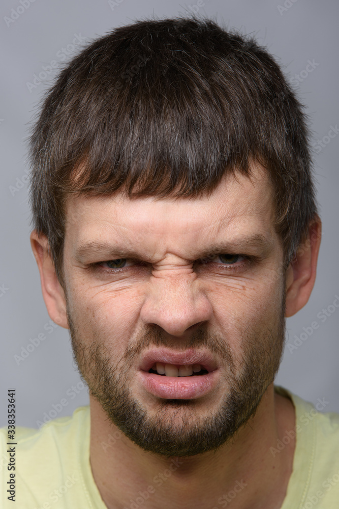 Closeup portrait of an evil man of European appearance Closeup portrait of an evil man of European appearance