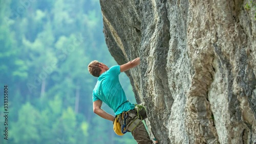 Rock climber elevating with struggle at Burjakove Peci Topla