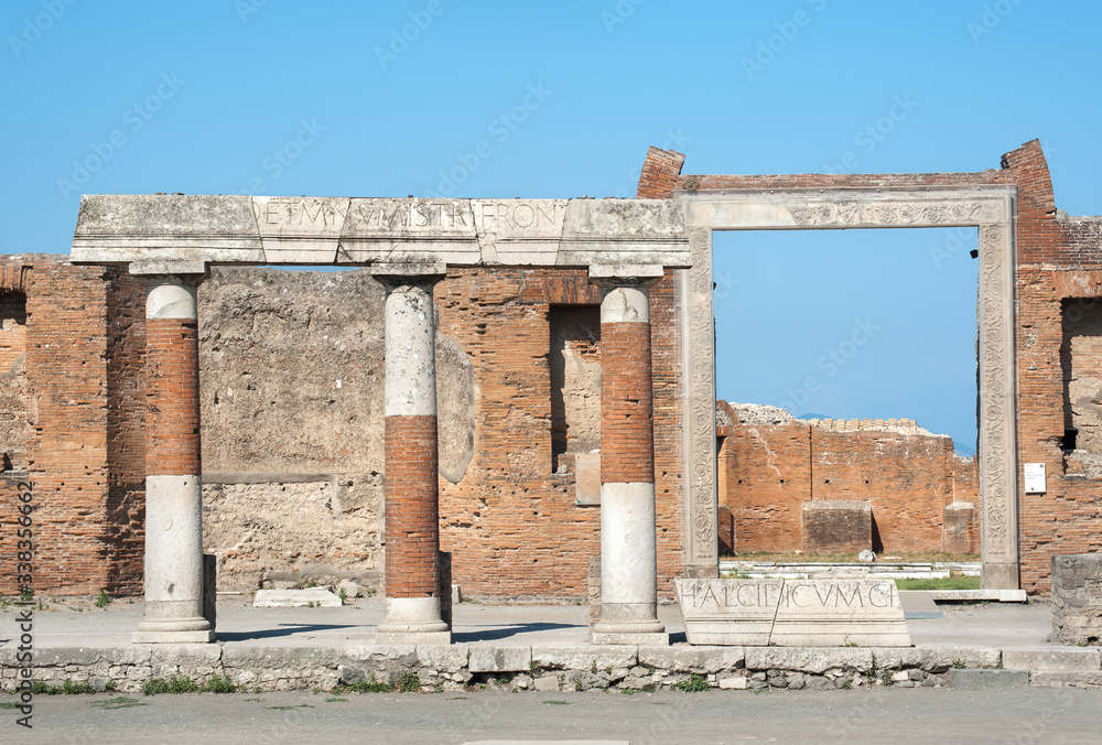 Colonnade with Latin inscriptions in front of the Building of Eumachia, Pompeii, Italy