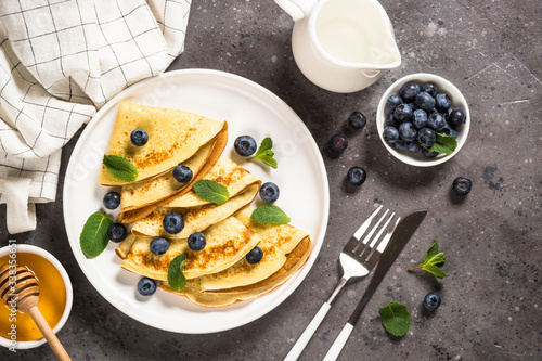 Crepes with blueberries and honey. photo