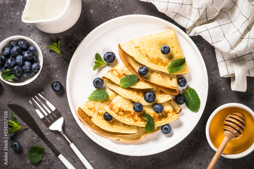 Crepes with blueberries and honey. photo