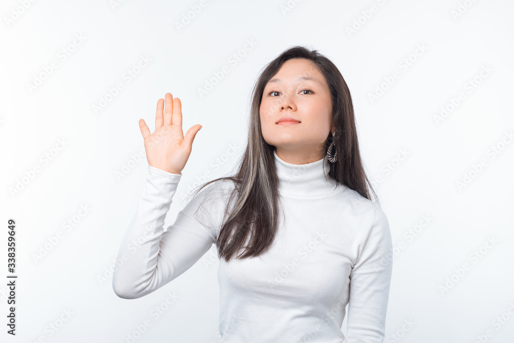 Hello. Photo of pretty young woman is showing hi gesture on white background. Hello. Photo of pretty young woman is showing hi gesture on white background.