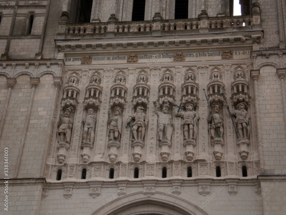 Angers, France - March 15th 2013 : detail of the facade of the cathedral Saint-Maurice. Focus on statues on the main facade.