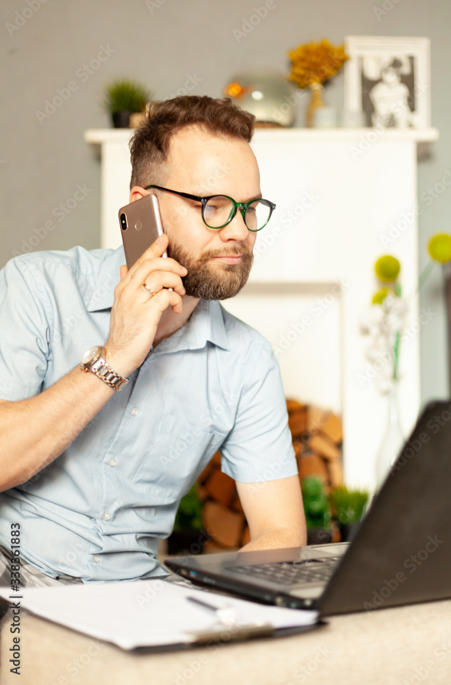 a man in pajamas works from home with a laptop computer a man in pajamas works from home with a laptop computer