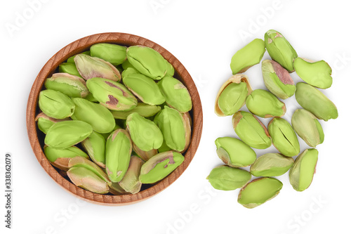 peeled pistachio in wooden bowl isolated on white background with clipping path and full depth of field. Top view. Flat lay