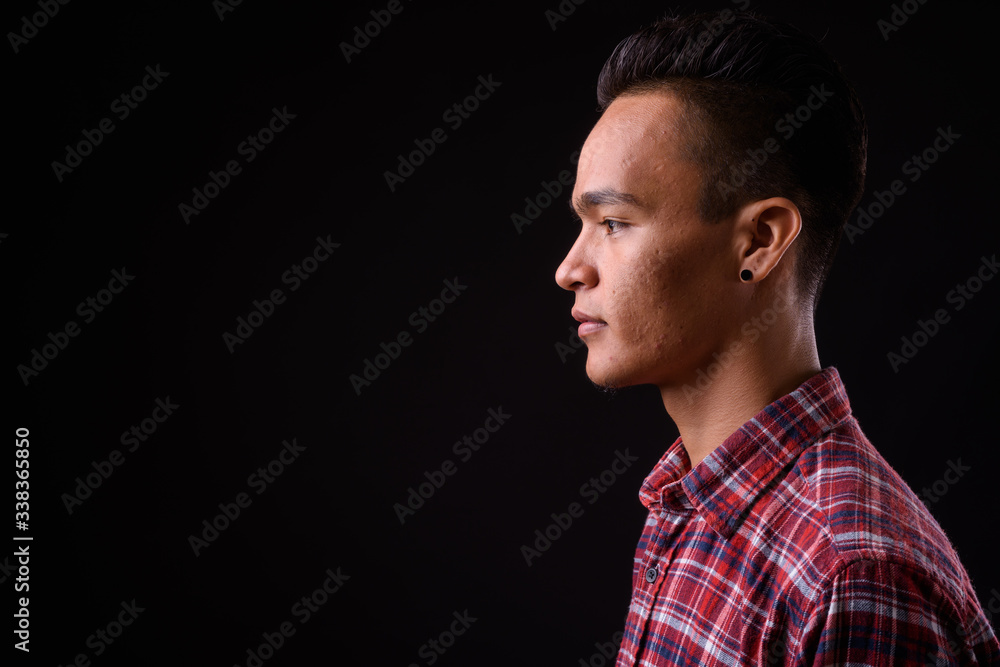 Closeup profile view of young handsome Indian hipster man Closeup profile view of young handsome Indian hipster man