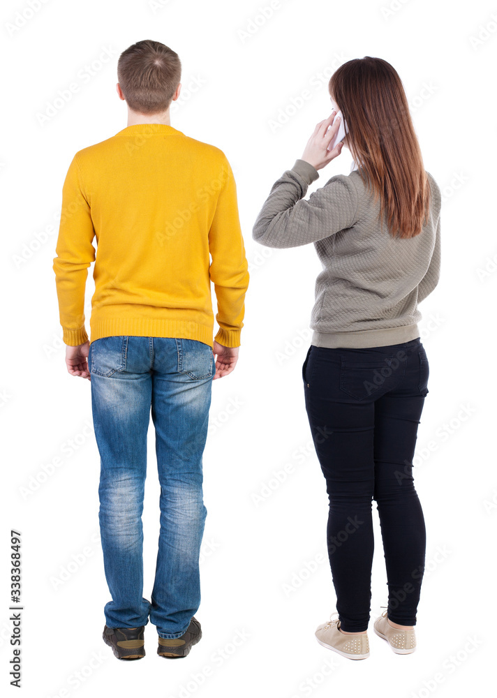 Back view of couple in sweater with mobile phone. Back view of couple in sweater with mobile phone.