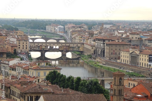 View of the city of Florence Italy from above at sunset highlights the Ponte Vecchio.