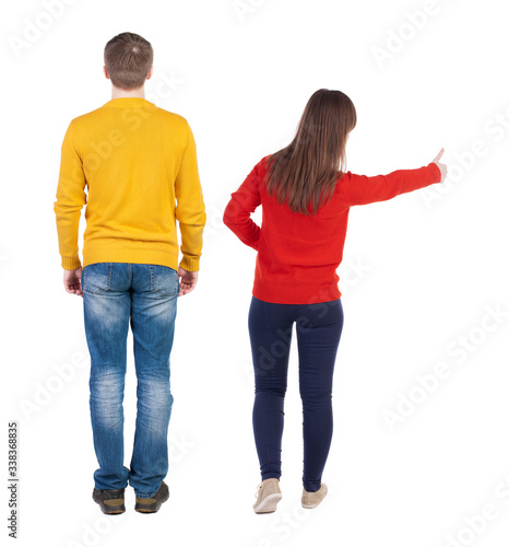 Back view of couple in sweater showing thumbs up.