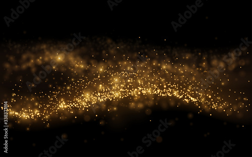 Gold light shine particles on black background