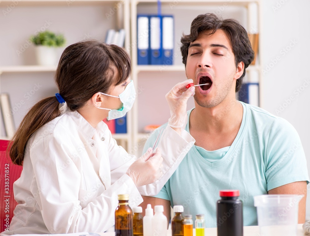 Young handsome man visiting female doctor dentist for removal of Young handsome man visiting female doctor dentist for removal of