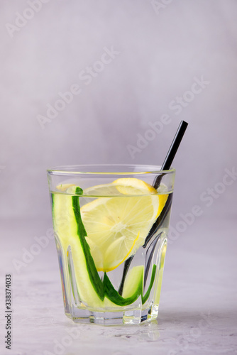 Glasses of Healthy Detox Water with Lemon and Cucumbers Diet Drink Straw Vertical