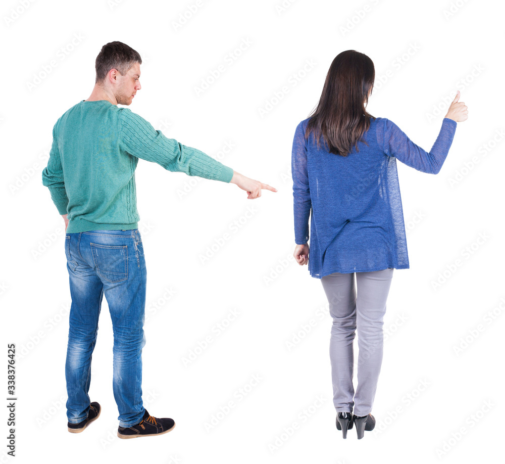 Obraz premium Back view of couple in sweater pointing.