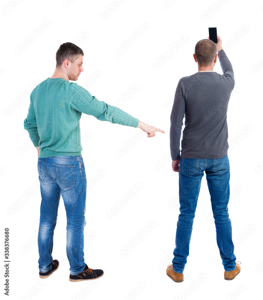 Back view of two man in sweater with mobile phone. Back view of two man in sweater with mobile phone.