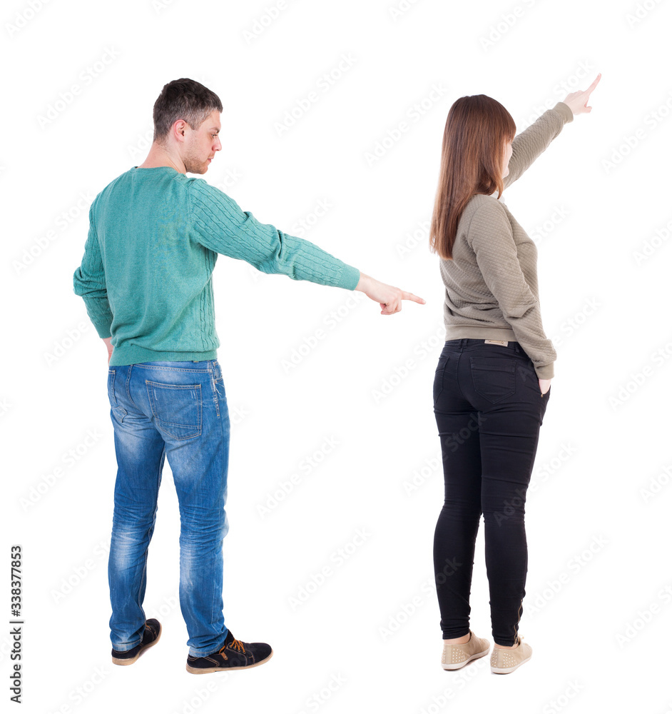 Back view of couple in sweater pointing. Back view of couple in sweater pointing.