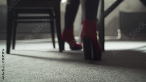 Wallpaper Mural girl in red high heel shoes walks on the floor and sits on a chair Torontodigital.ca