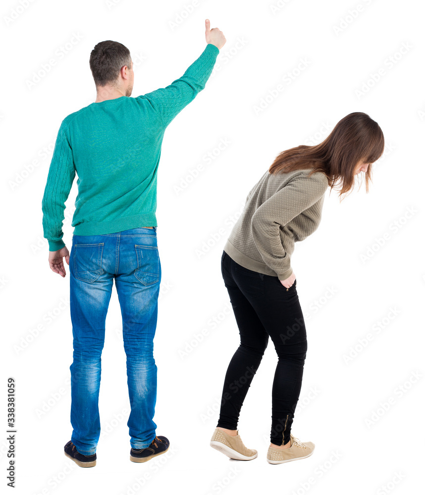 Back view of couple in sweater showing thumbs up. Back view of couple in sweater showing thumbs up.