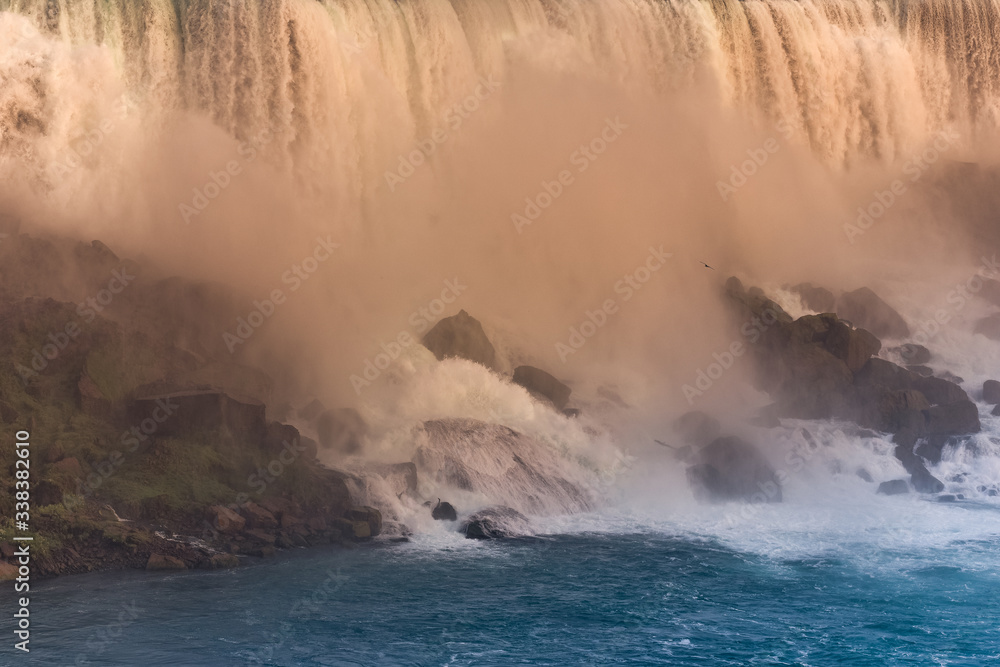 Close-up of the waterfall on the U.S. side at sunset. Concept of nature and travel. Niagara Falls, Canada. United States of America