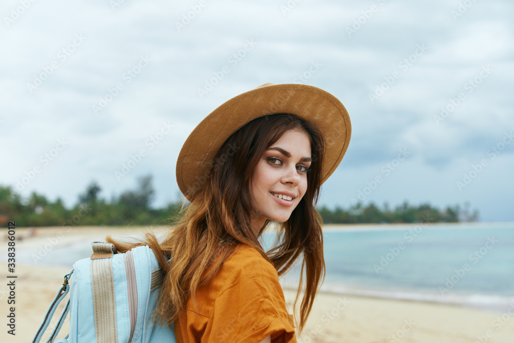 young woman with hat on the beach