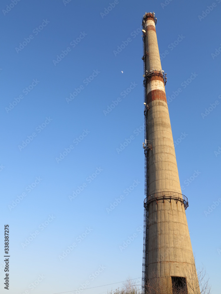 a large tower or pipe in a dilapidated factory