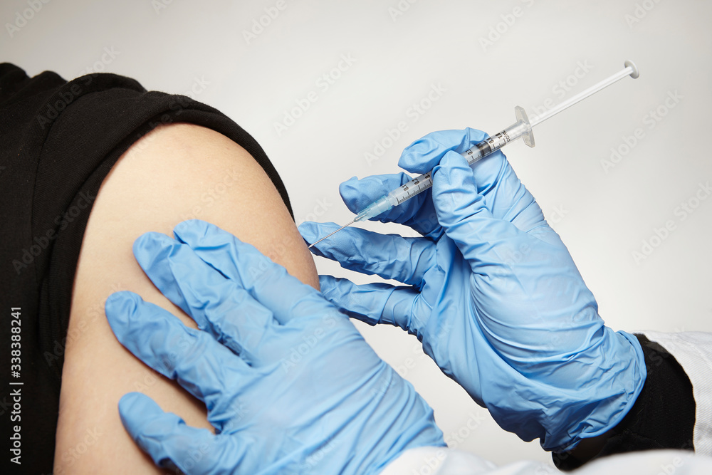 Fototapeta premium Detail of vaccinating unknown man with covid-19 disease vaccine