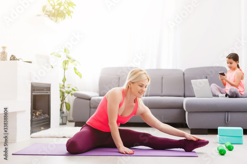 Horizontal view of a woman doing yoga at home