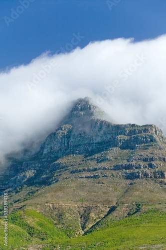 Clouds blow over Table Mountain and mountains behind Cape Town  South Africa