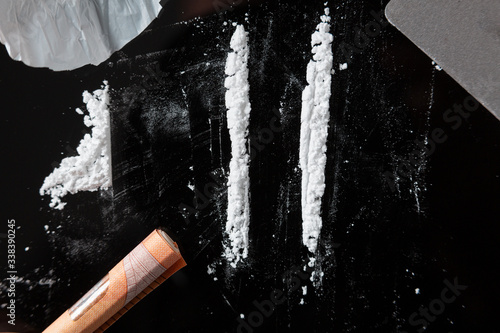 Two Cocaine lines prepared on a table photo