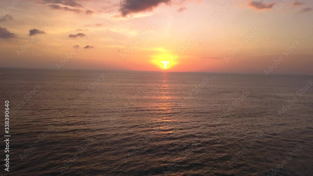 High angle drone view of the sunset at the beach in Canggu, Bali Indonesia, flying backwards High angle drone view of the sunset at the beach in Canggu, Bali Indonesia, flying backwards