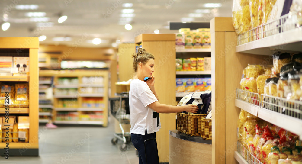Woman choosing a dairy products at supermarket	
