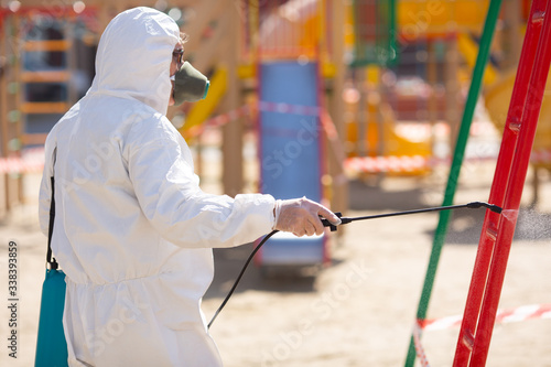 Man in hazmat suit cleaning and disinfecting coronavirus cells epidemic MERS-CoV virus disinfect protection concept 2019-nCoV pandemic health risk