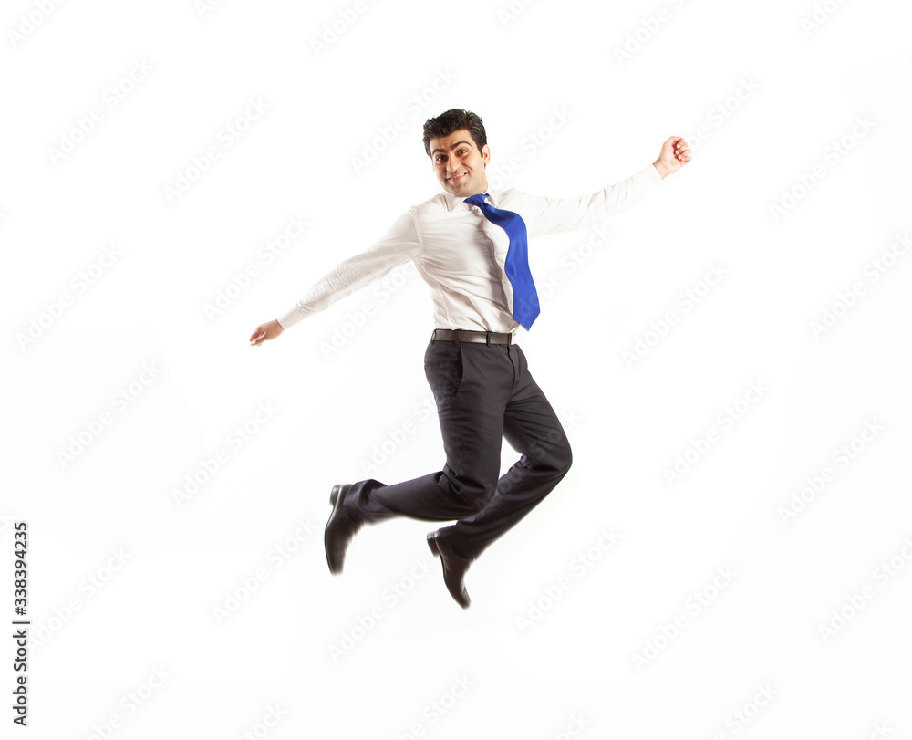 Young office corporate man jumping high spreading his arms with joy wearing blue tie isolated on a white background Young office corporate man jumping high spreading his arms with joy wearing blue tie isolated on a white background