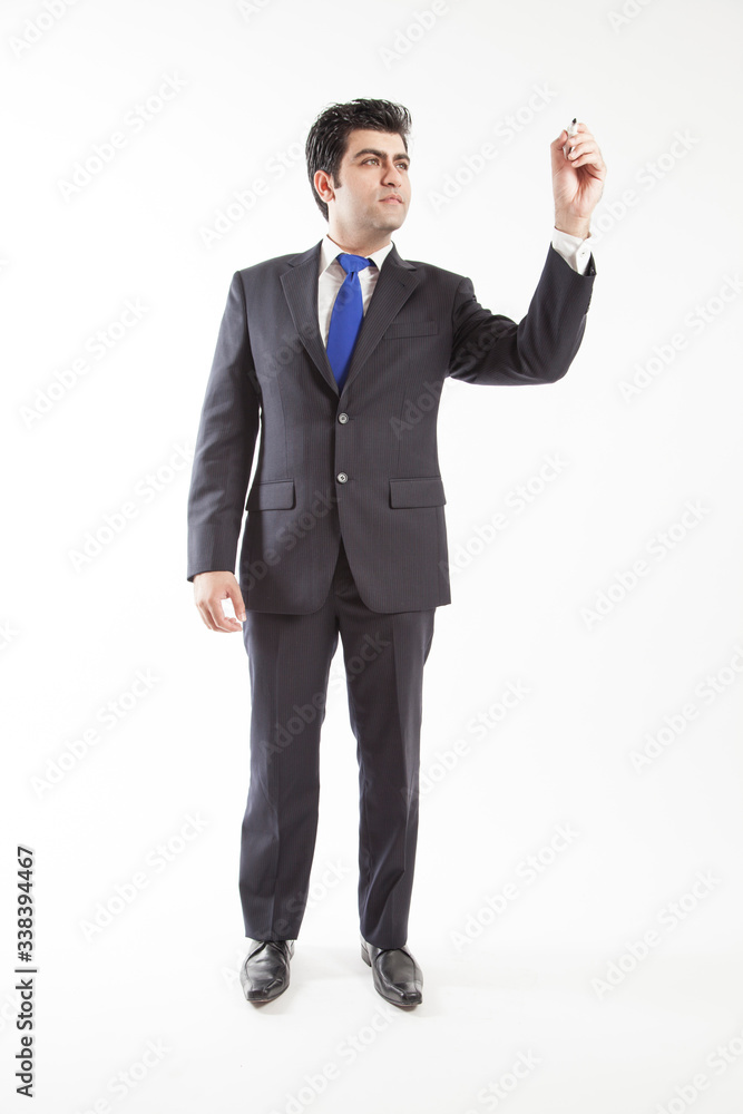 Business man wearing suit pretends to write on screen camera holding marker front view Business man wearing suit pretends to write on screen camera holding marker front view