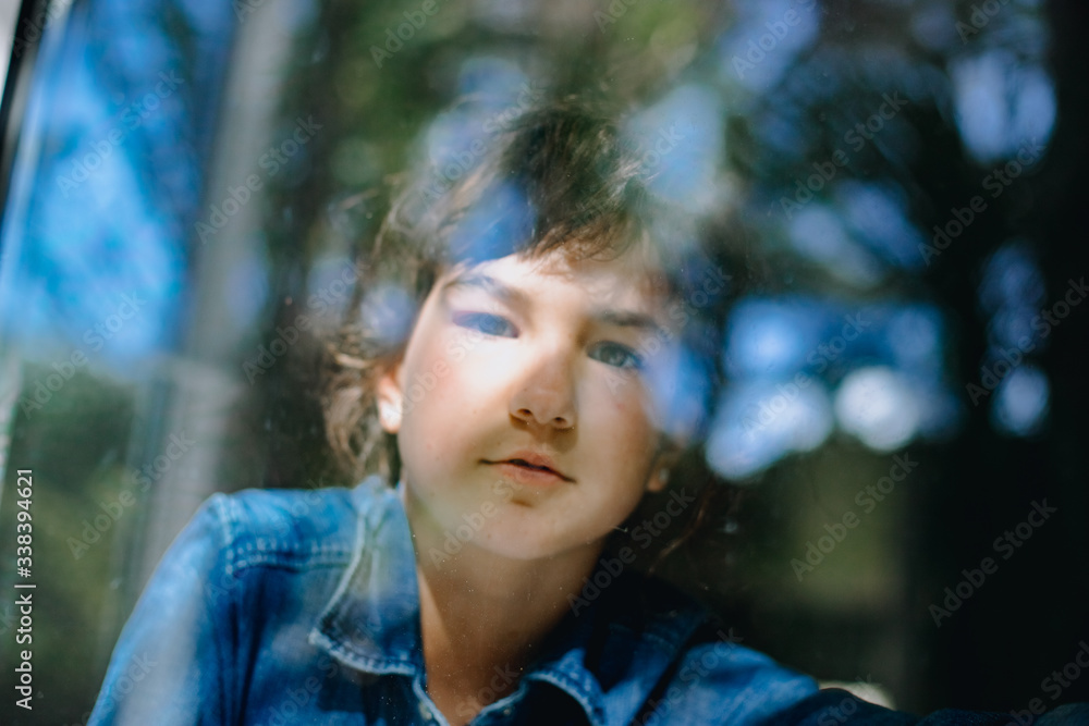 young girl looking out from the window