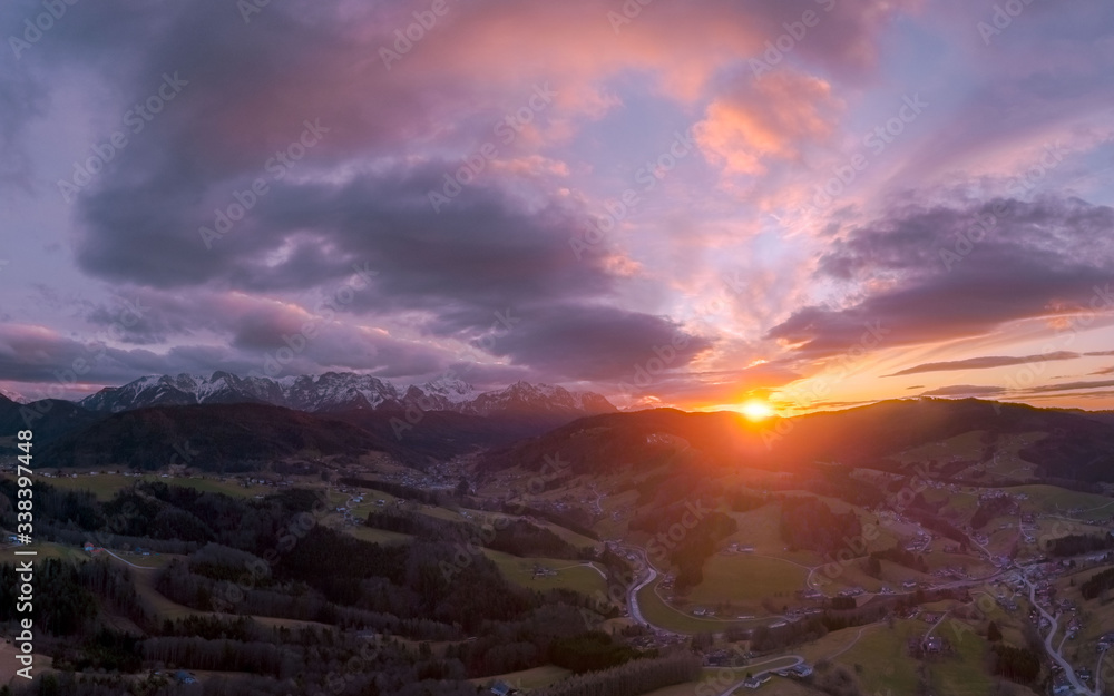 Fototapeta premium Sunset over the Austrian Alps after a Rainy day in February, with snow on the mountain tops