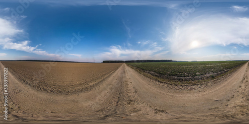 full seamless spherical hdri panorama 360 degrees angle view on no traffic gravel road among fields in spring day with clear sky in equirectangular projection, ready for VR AR virtual reality content